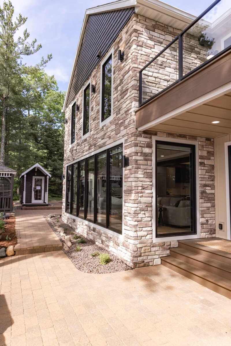 whole home remodel exterior stone and paver patio below deck minocqua wi