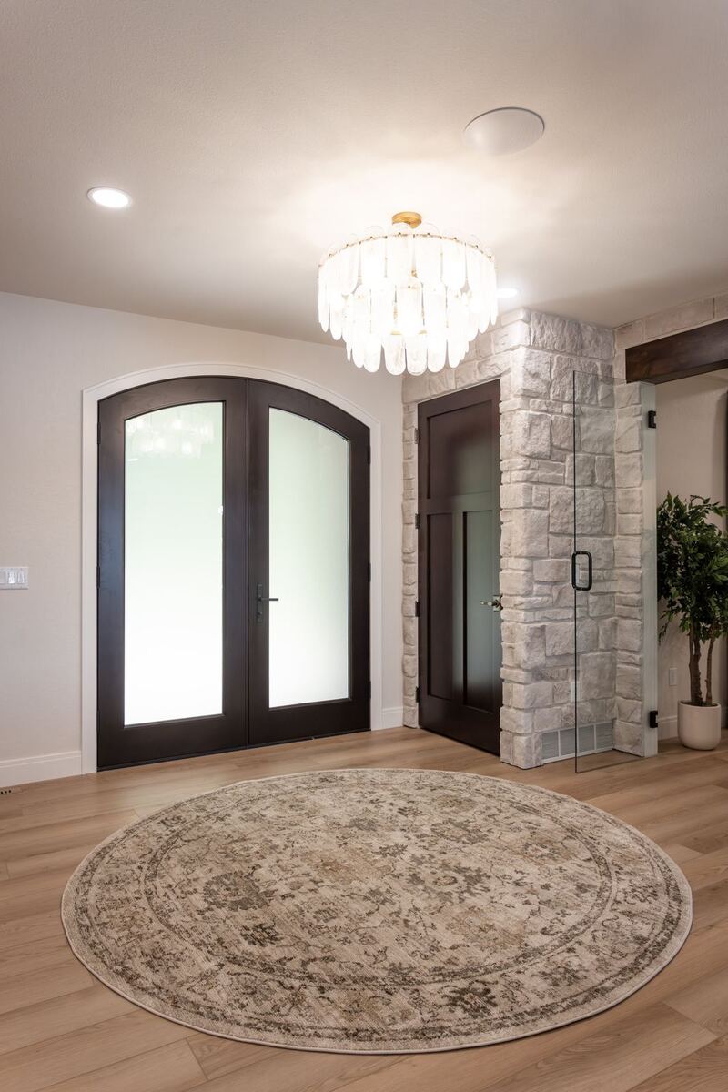 whole home remodel foyer with arched double doors and round rug minocqua wi