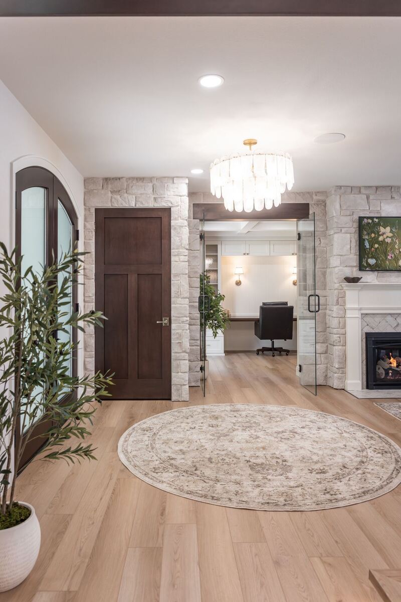whole home remodel foyer with crystal chandelier and stone walls minocqua wi