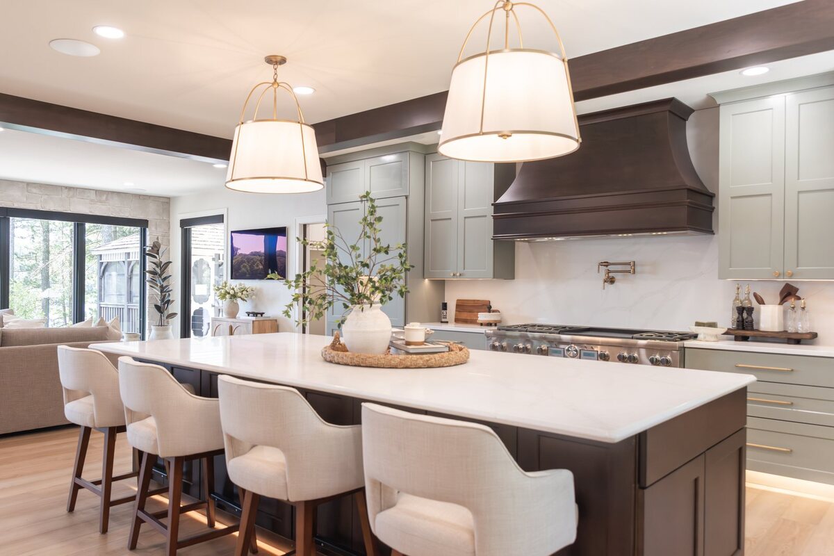 whole home remodel kitchen island with upholstered stools and wood range hood minocqua wi