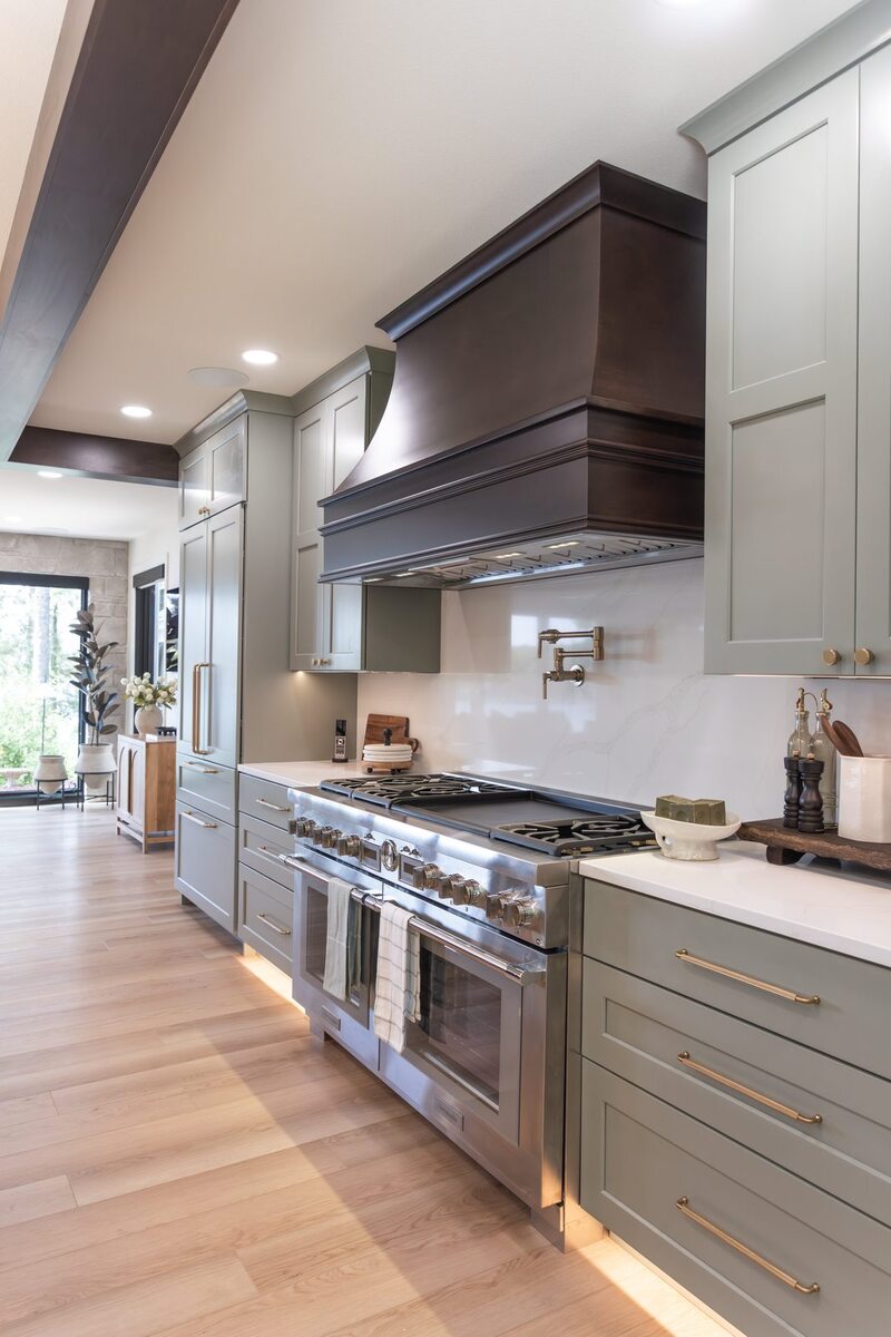whole home remodel kitchen range wall with pot filler and sage cabinets minocqua wi