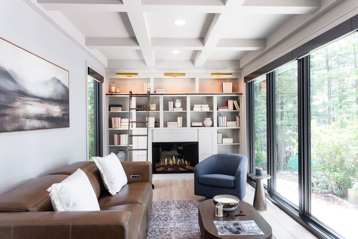 whole home remodel library electric fireplace built-ins with brass picture lights minocqua wi