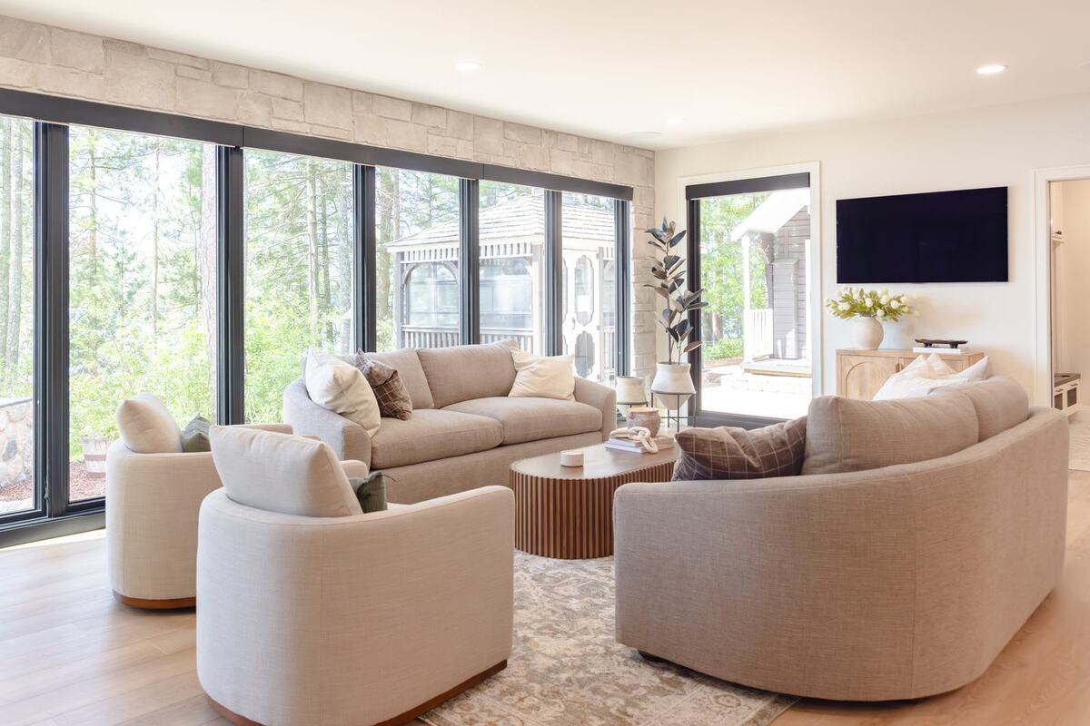 whole home remodel living room swivel chairs and curved sofa with window wall minocqua wi