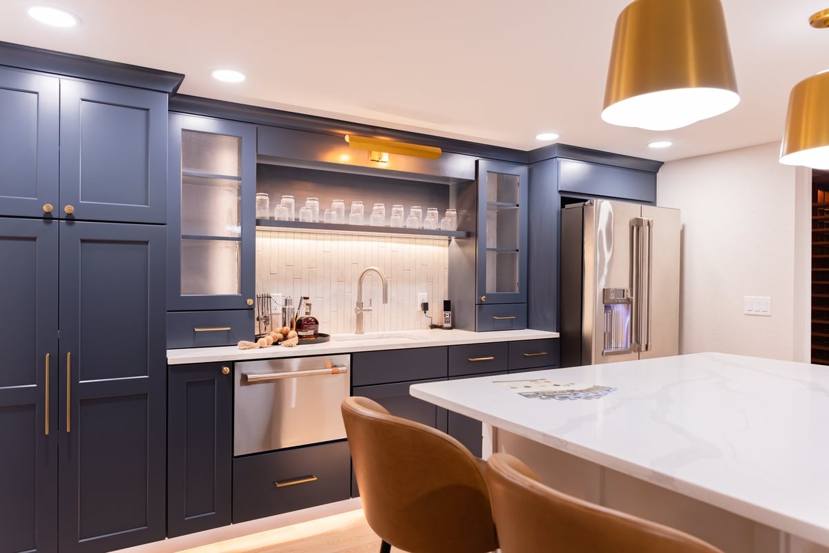 whole home remodel lower level wet bar angled view with quartz island and leather stools minocqua wi