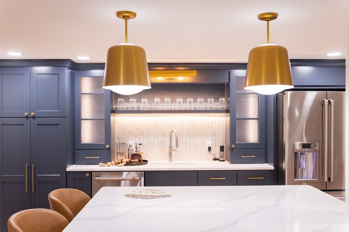 whole home remodel lower level wet bar with navy cabinets and brass pendants minocqua wi