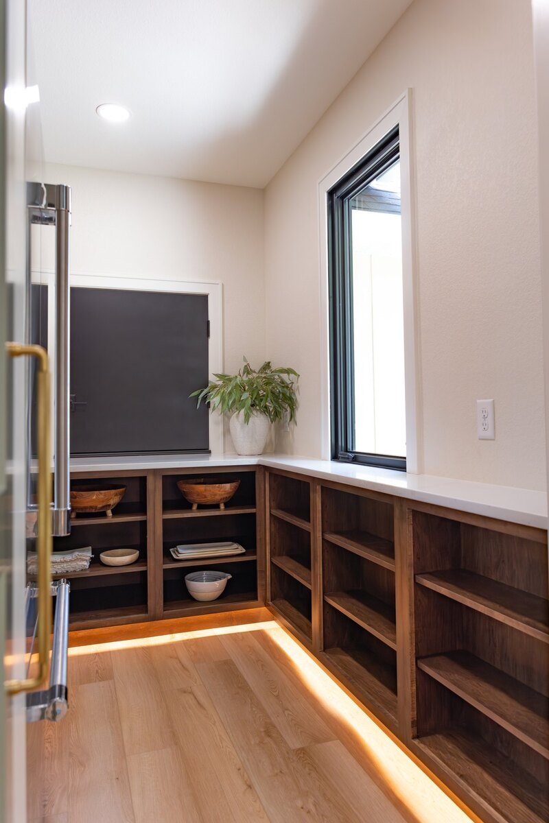 whole home remodel walk-in pantry open shelving and window angled view minocqua wi