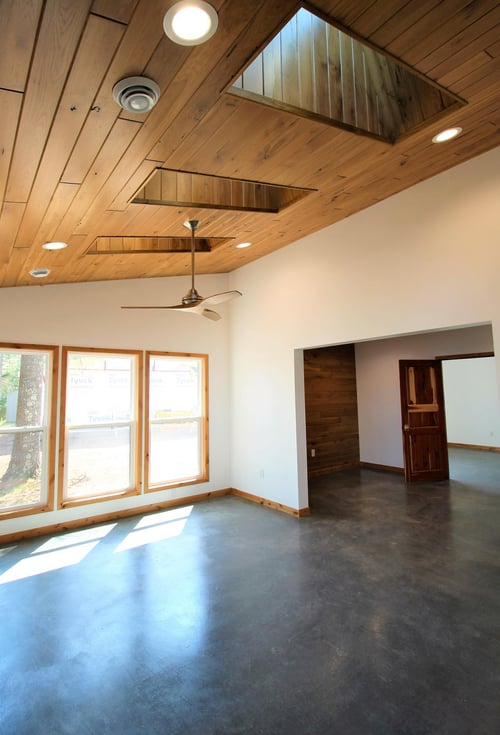 Custom sunroom with vaulted wood ceiling and large windows by Ross Construction in Lake Dubay, WI.