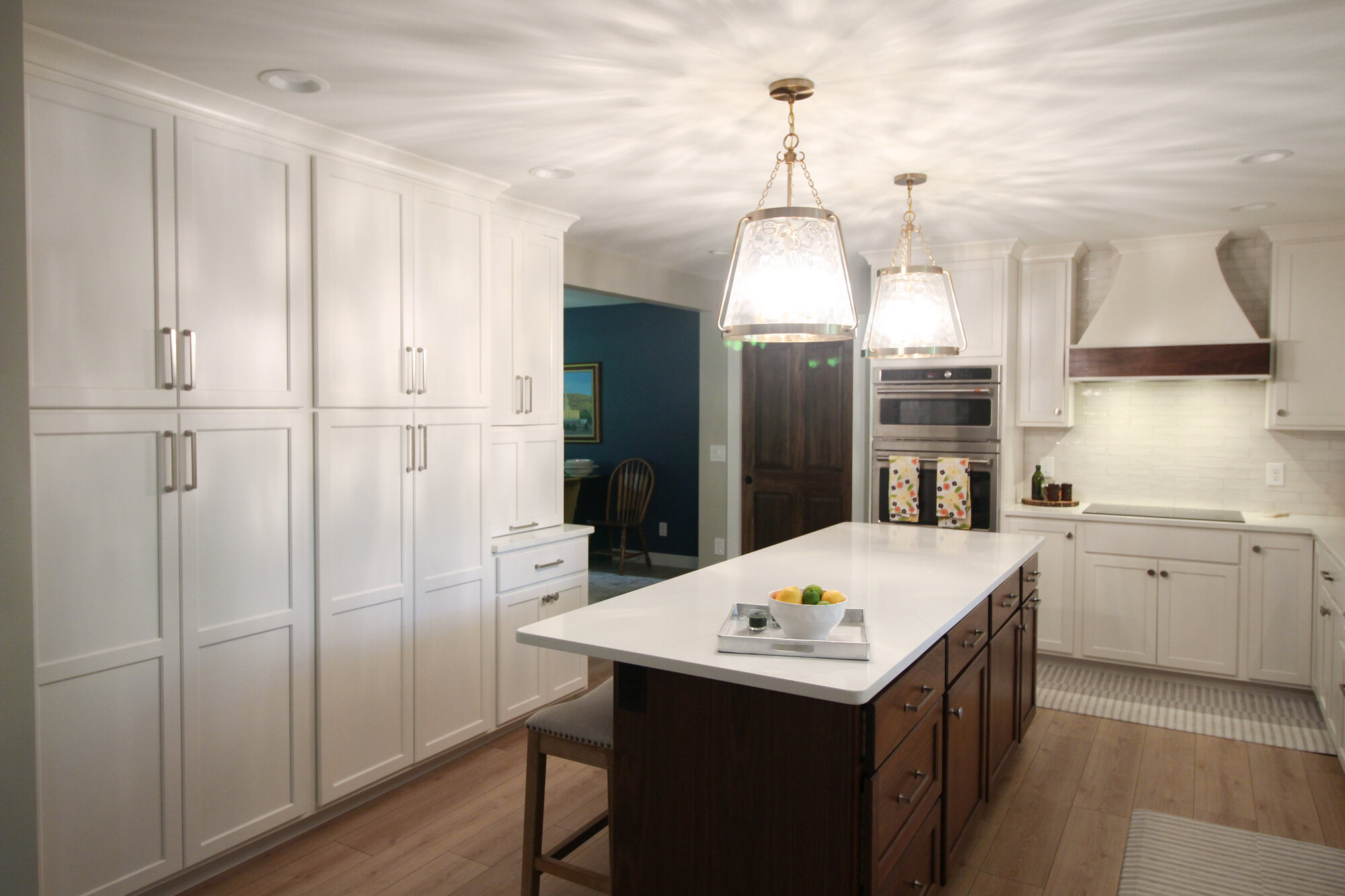Bright kitchen remodel with pendant lighting and bar stools by Ross Construction in Rib Mountain, WI.