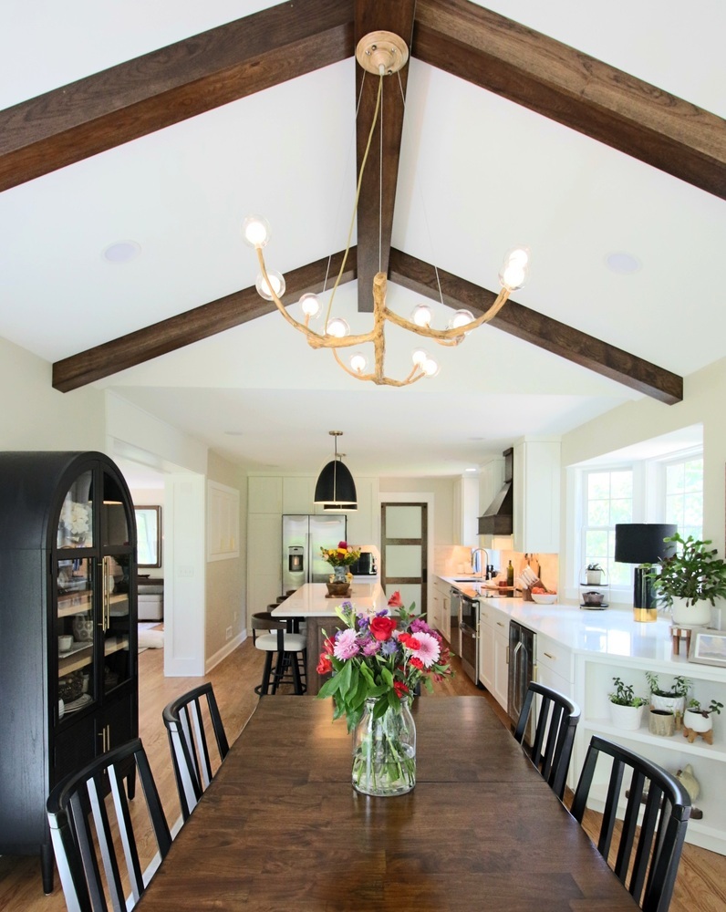 Vaulted ceiling kitchen and dining area with exposed beams in Ross Construction custom home in Wausau, WI.