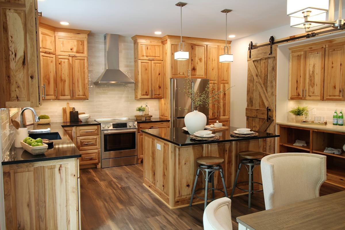 Custom kitchen in a Marathon, WI home by Ross Construction featuring hickory cabinets and stainless steel appliances.