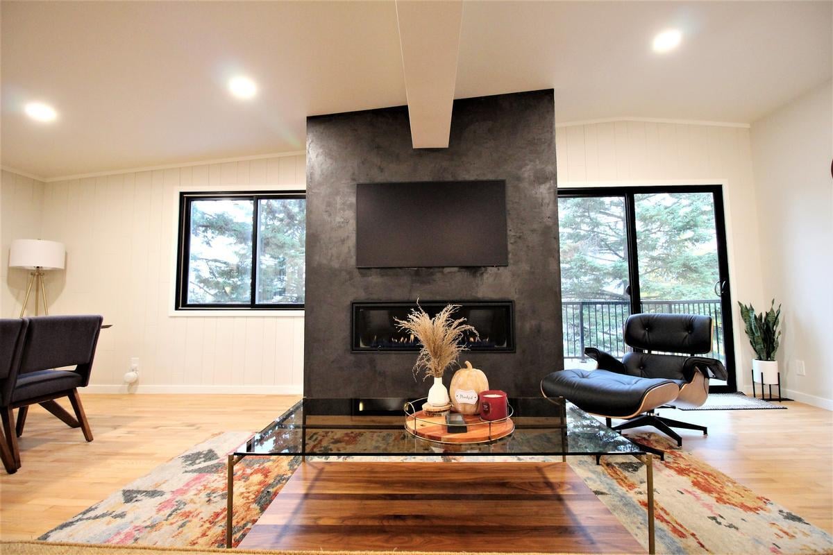 Centerpiece fireplace wall with mounted TV in a Marathon custom home by Ross Construction.
