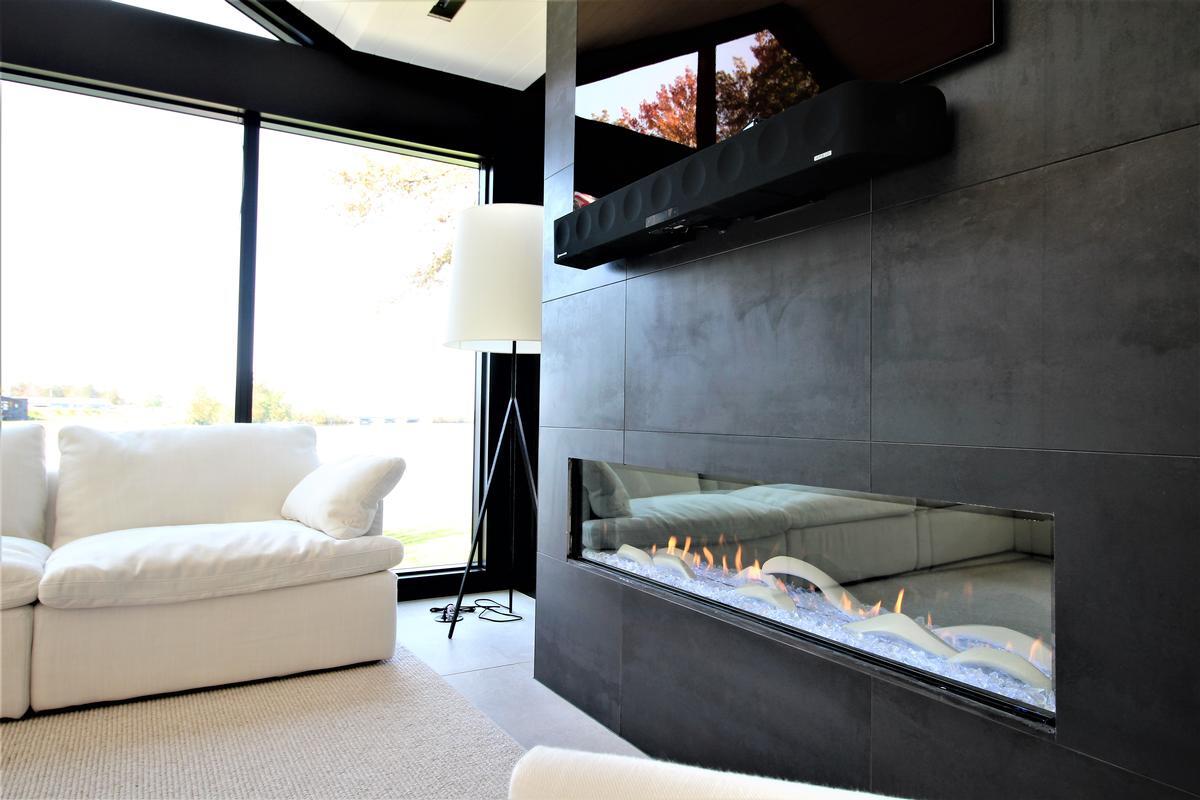 Close-up of modern fireplace with black tile wall in a Ross Construction custom home in Lake Dubay, WI.