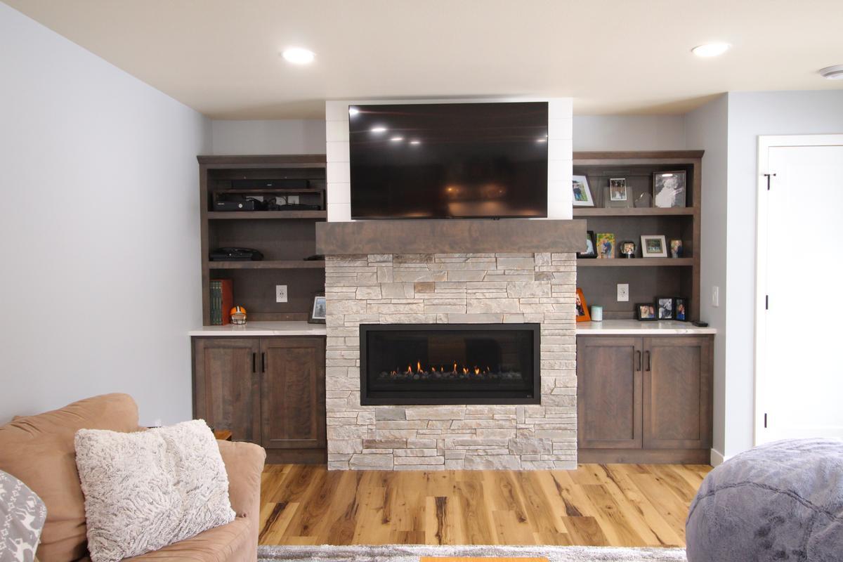 Built-in entertainment center with fireplace and shelving by Ross Construction in Lake Dubay, WI.