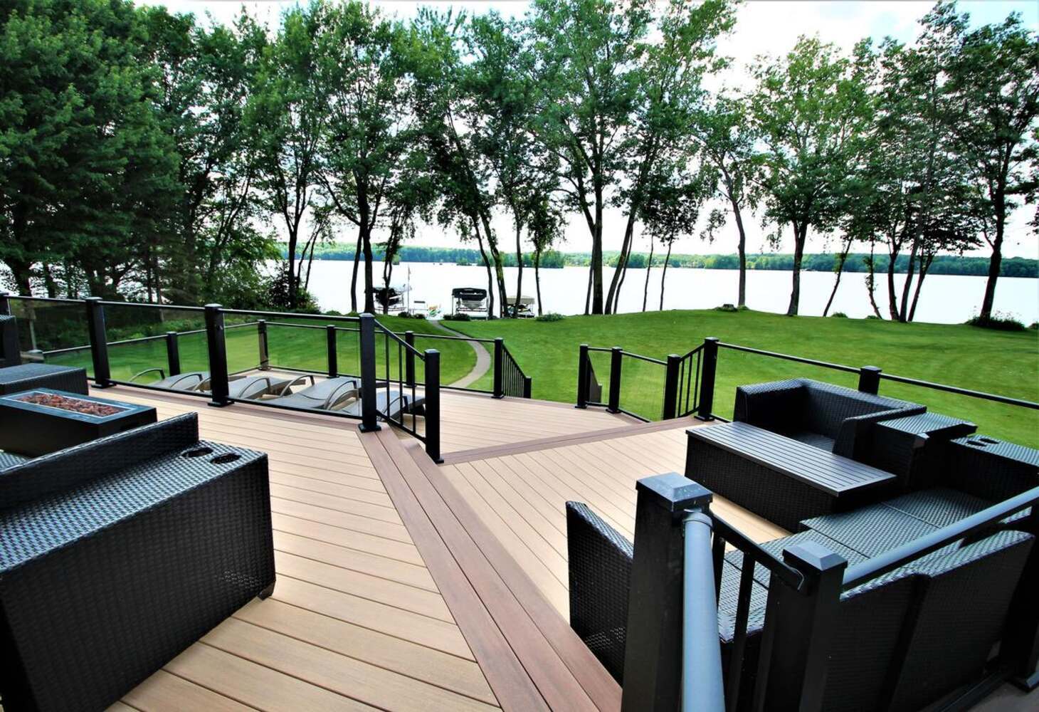 Lakefront patio with modern seating and scenic view in Rib Mountain, WI by Ross Construction