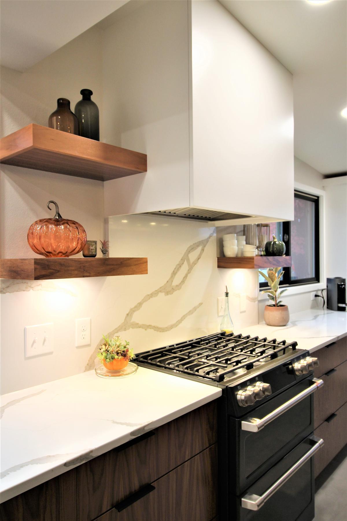 Warm-toned custom kitchen with stainless appliances designed by Ross Construction in Rib Mountain, WI.
