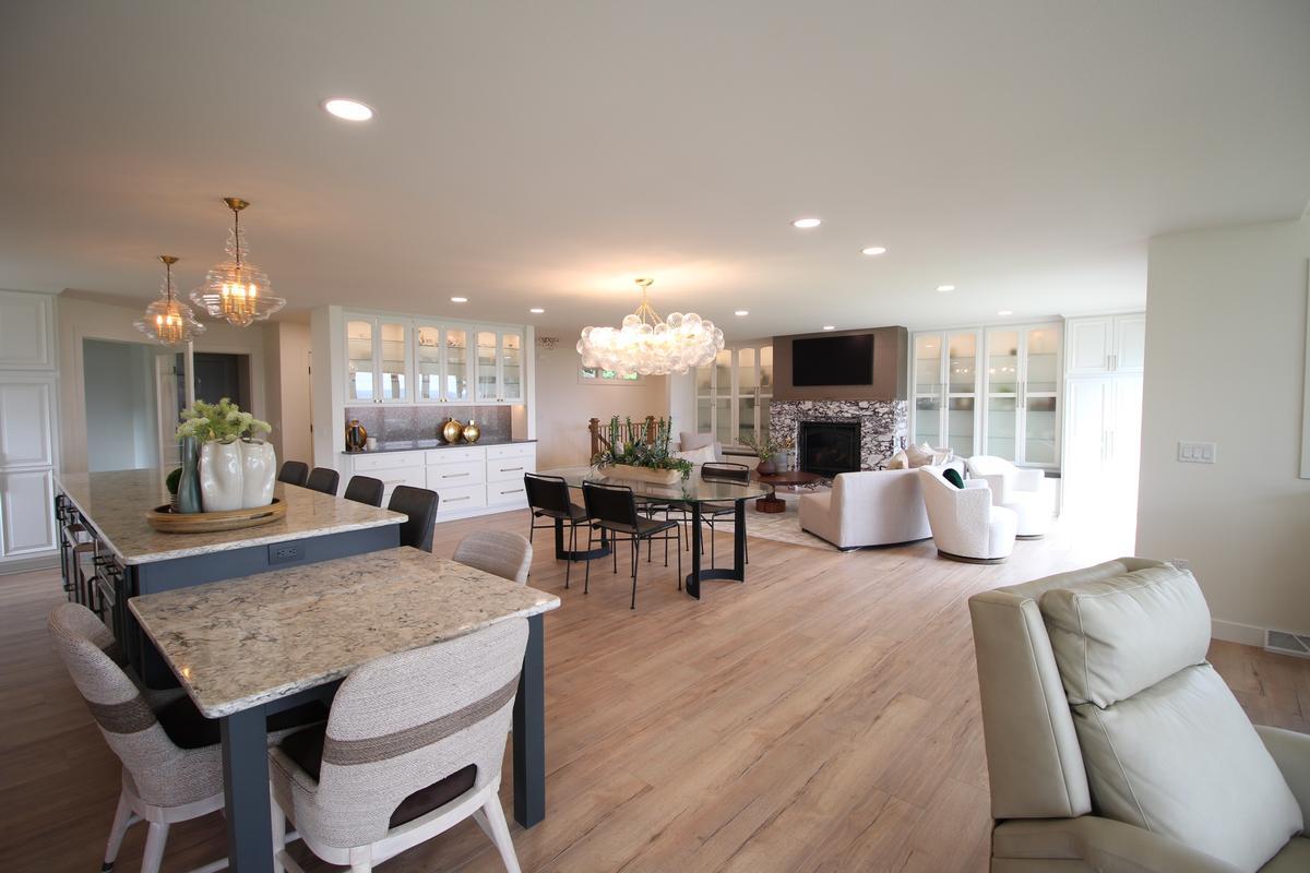 Spacious interior layout featuring dining, kitchen, and lounge areas by Ross Construction in Marathon, WI