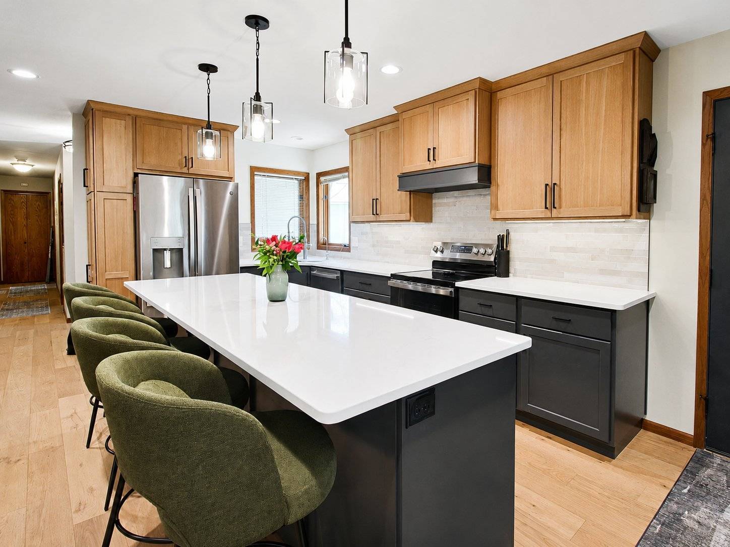 kitchen remodel two tone cabinets white island green barstools pendant lights